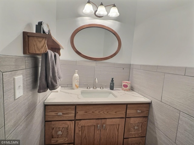 bathroom with vanity and tile walls