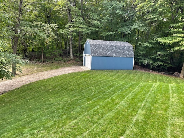 view of yard featuring a storage unit and a garage