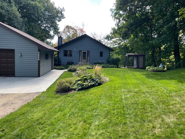 8834 Bishop Ave NW, Maple Lake, MN 55358 - view of green lawn featuring an outbuilding, a garage, and driveway