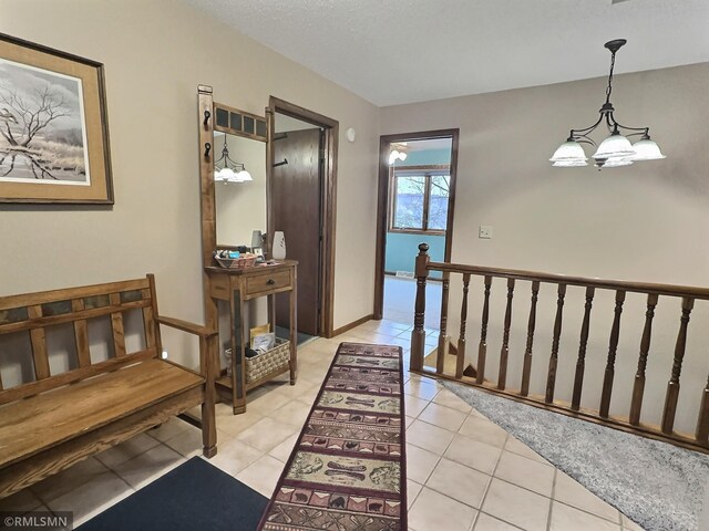 8834 Bishop Ave NW, Maple Lake, MN 55358 - hallway with a chandelier, an upstairs landing, and light tile patterned floors