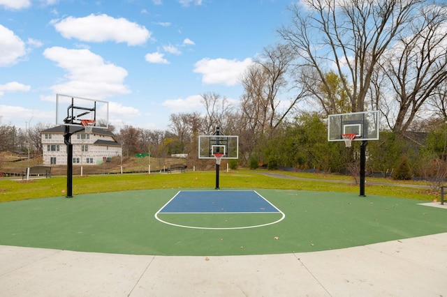 view of sport court featuring a lawn