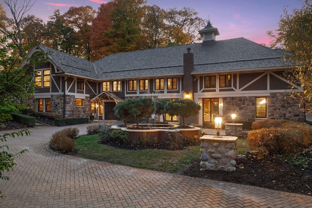 view of back house at dusk