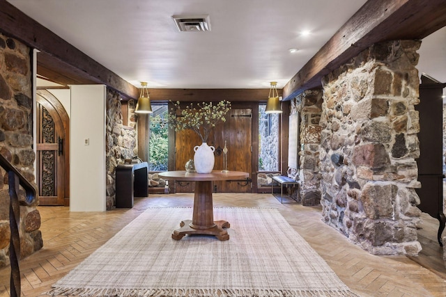 foyer with beamed ceiling