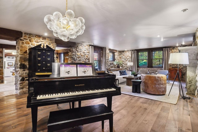 miscellaneous room featuring hardwood / wood-style floors and a chandelier