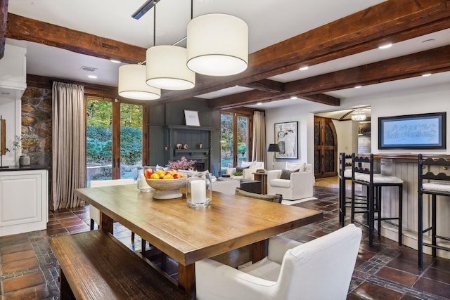 dining area with french doors, beam ceiling, and a wealth of natural light