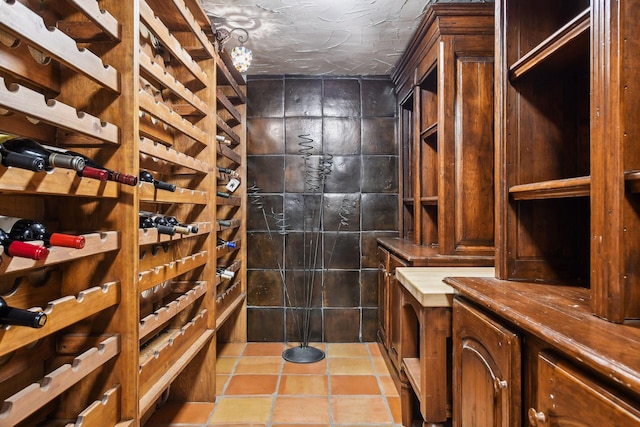 wine area featuring tile patterned floors and a textured ceiling