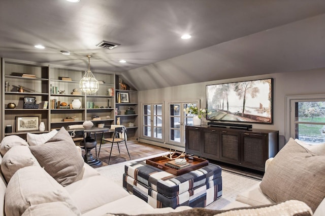 living room with light hardwood / wood-style flooring, lofted ceiling, baseboard heating, and a chandelier