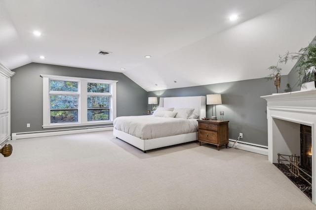 bedroom featuring a baseboard heating unit, light colored carpet, and vaulted ceiling