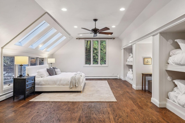 bedroom featuring a baseboard heating unit, radiator heating unit, ceiling fan, dark wood-type flooring, and vaulted ceiling with skylight