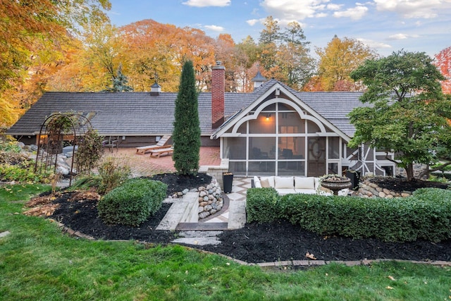 rear view of property with a patio and a sunroom