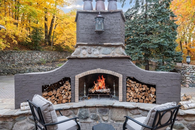 view of patio with exterior fireplace