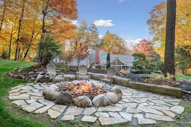 view of yard with an outdoor fire pit and a patio area