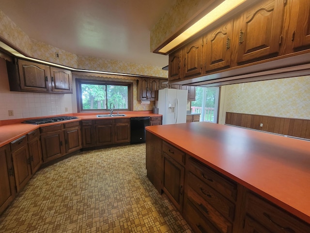 5330 500th St, Kenyon Twp, MN 55946 - kitchen with white refrigerator with ice dispenser, dishwasher, wallpapered walls, plenty of natural light, and gas stovetop
