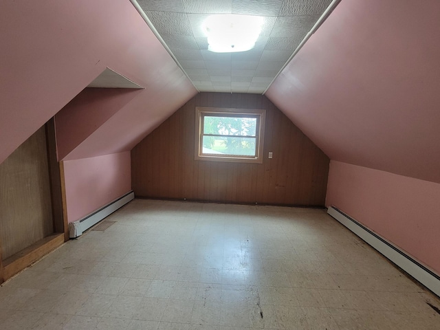 5330 500th St, Kenyon Twp, MN 55946 - additional living space with a baseboard radiator, light floors, vaulted ceiling, and wood walls