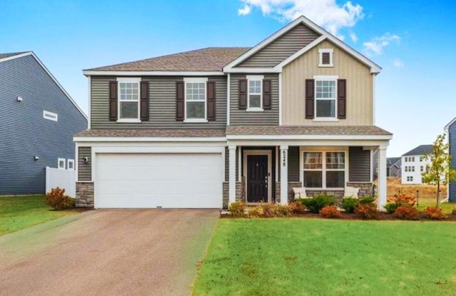 view of front of property with a garage and a front yard