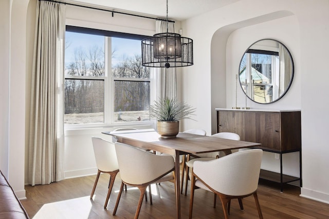 dining area featuring an inviting chandelier, hardwood / wood-style flooring, and plenty of natural light