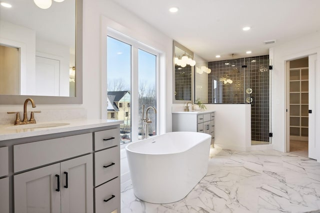 bathroom with independent shower and bath and vanity