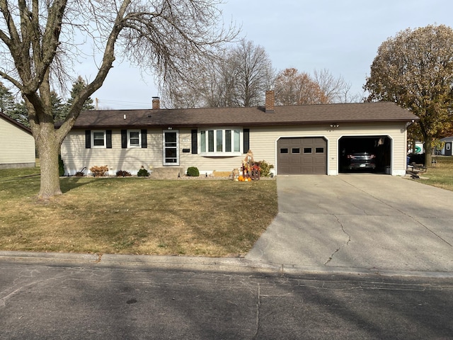 ranch-style house with a garage and a front lawn