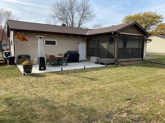 back of house with a patio, a sunroom, and a lawn