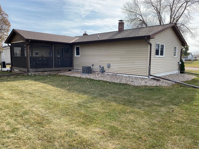 back of house with a lawn, central AC unit, and a sunroom