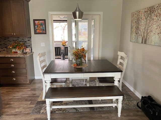 dining space with dark hardwood / wood-style flooring