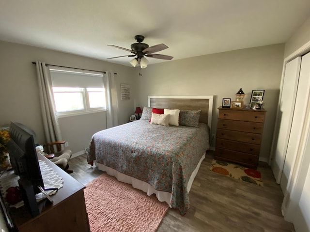 bedroom with a closet, hardwood / wood-style floors, and ceiling fan