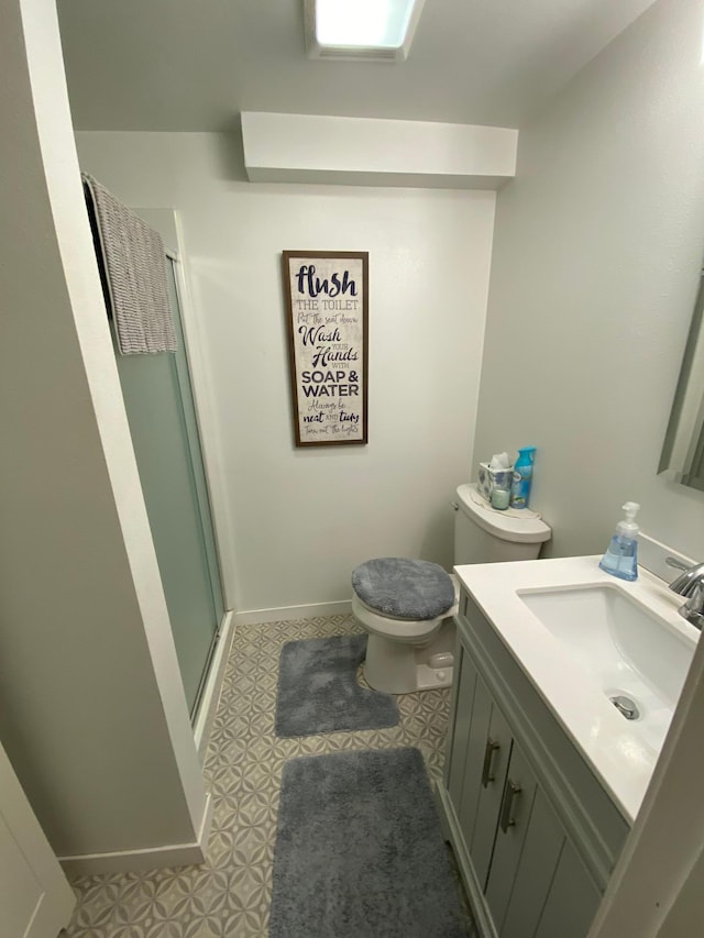 bathroom with vanity, an enclosed shower, toilet, and tile patterned flooring