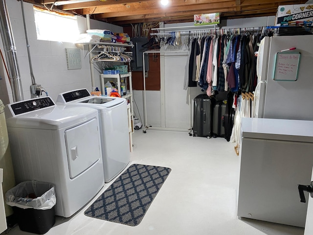 clothes washing area with electric panel and washer and clothes dryer