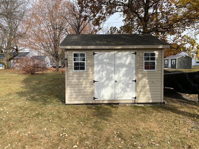 view of outbuilding with a lawn