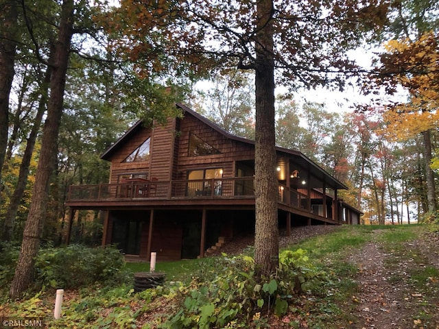 rear view of property with a wooden deck