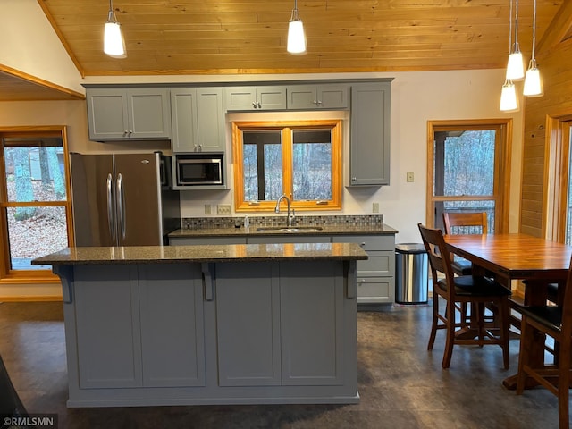 kitchen with appliances with stainless steel finishes, sink, hanging light fixtures, wooden ceiling, and vaulted ceiling