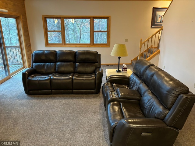 living room with wooden walls and carpet flooring