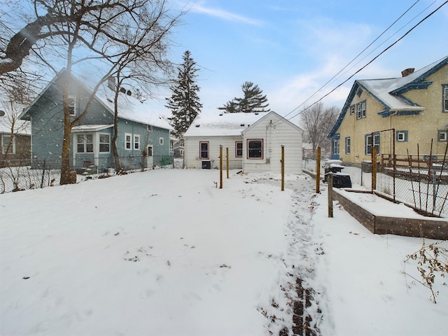 view of snow covered rear of property