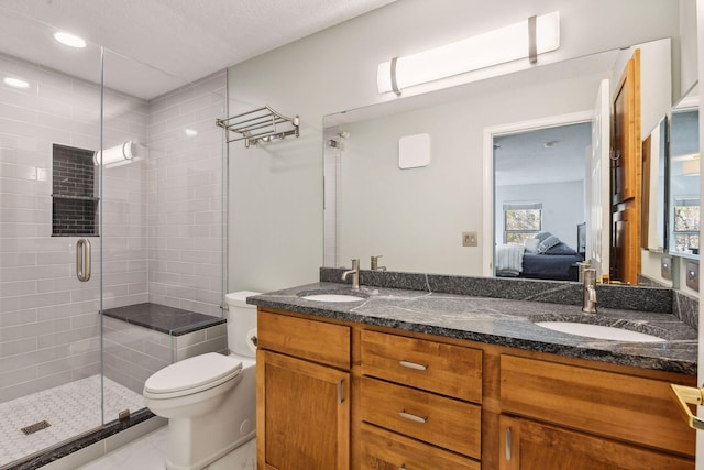 bathroom featuring tile patterned floors, vanity, toilet, and an enclosed shower