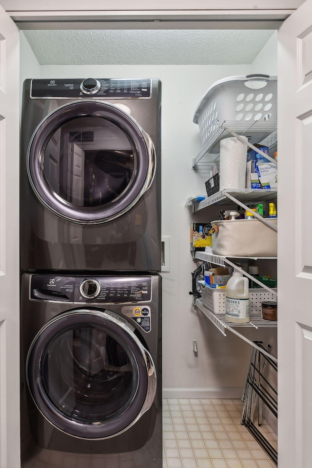 clothes washing area with stacked washer and dryer