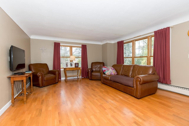 living room with light wood-type flooring and a baseboard heating unit