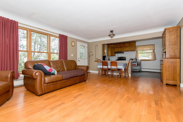 living room featuring light wood-type flooring and a baseboard radiator