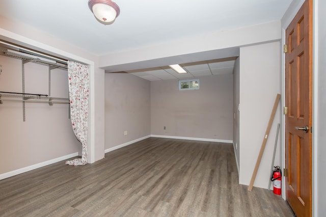 basement with hardwood / wood-style flooring