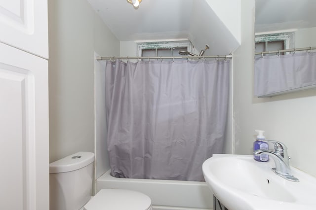 full bathroom with toilet, shower / bath combo with shower curtain, and sink