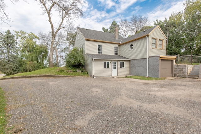 back of property with a garage