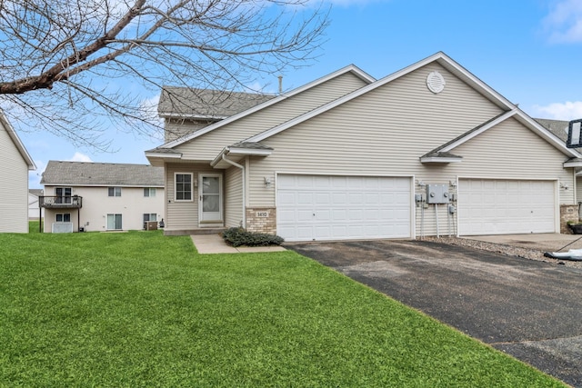 view of front of home with a garage and a front yard