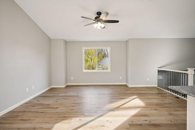 unfurnished room with light wood-type flooring and ceiling fan