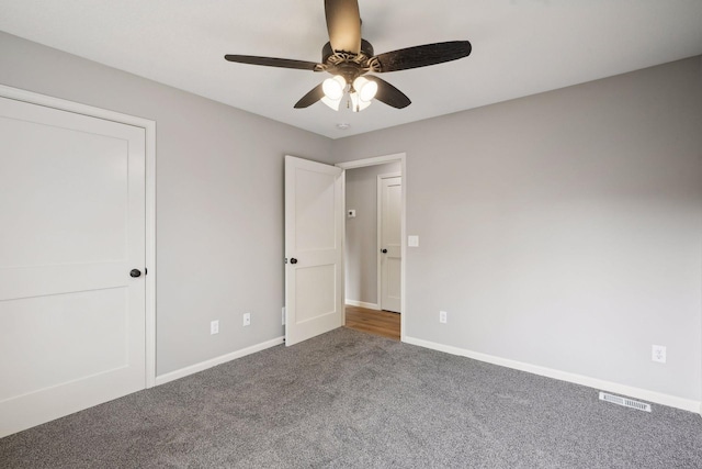 unfurnished bedroom with carpet, a closet, and ceiling fan