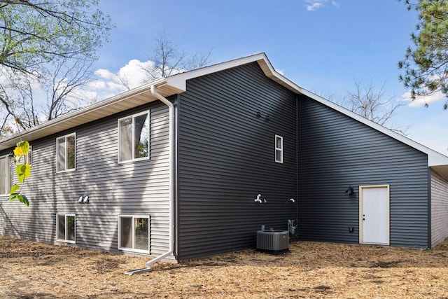 view of side of property featuring central AC