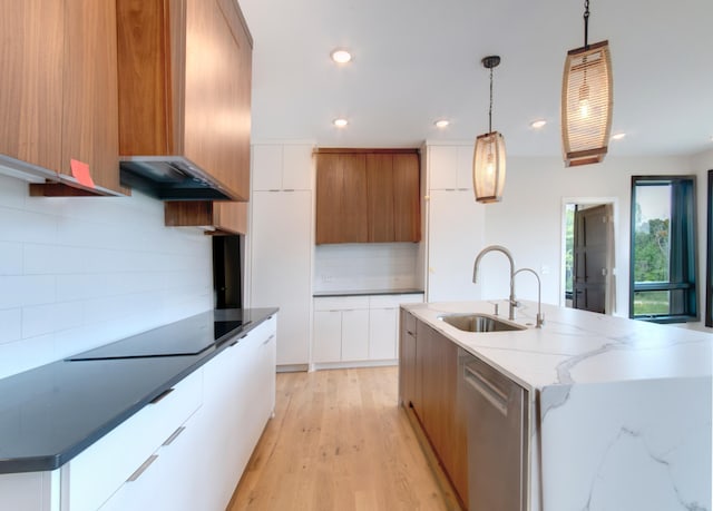 kitchen with backsplash, white cabinets, and pendant lighting