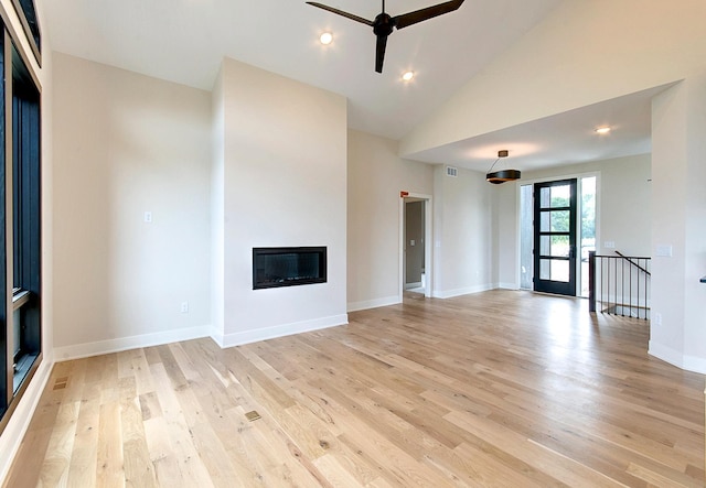 unfurnished living room with ceiling fan, light hardwood / wood-style flooring, and high vaulted ceiling