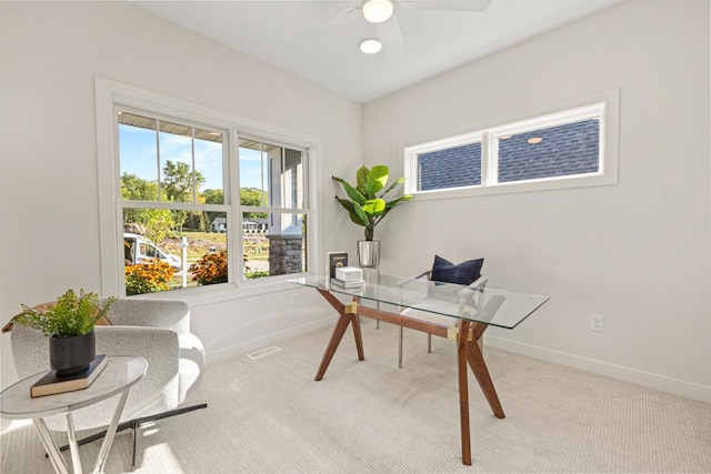 carpeted home office with ceiling fan