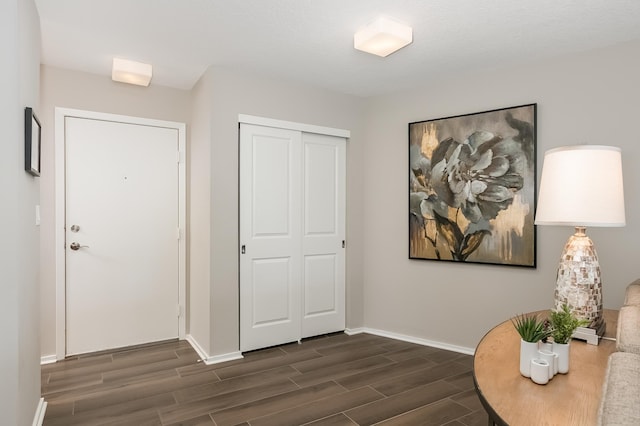 entryway featuring a textured ceiling and dark hardwood / wood-style floors