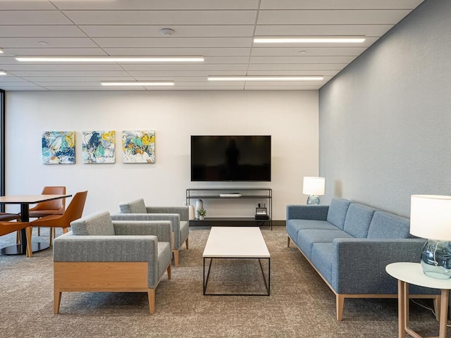 living room with carpet and a drop ceiling