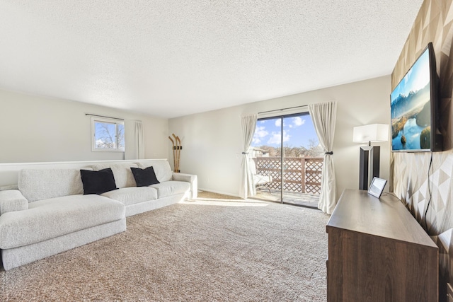 living room featuring plenty of natural light, carpet, and a textured ceiling